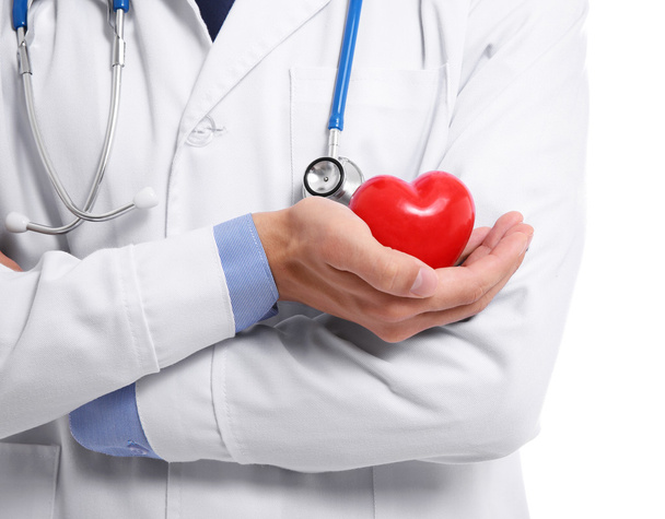 Male doctor holding red heart on white background - Photo, Image