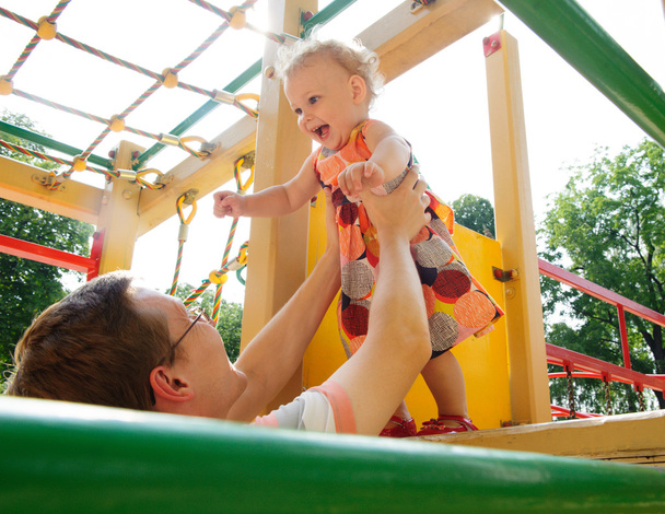 Father with daughter on playground - Valokuva, kuva
