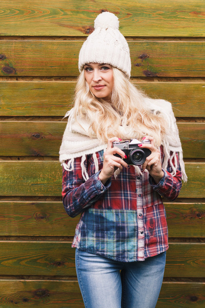 Young attractive woman holds old camera - Φωτογραφία, εικόνα