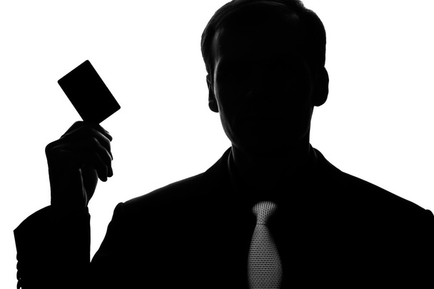 Portrait young man in suit, tie with plastic card - silhouette - Photo, Image