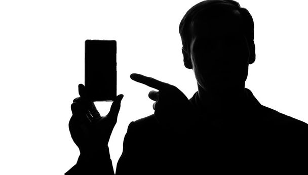 Young man in suit point on smartphone - Foto, Bild