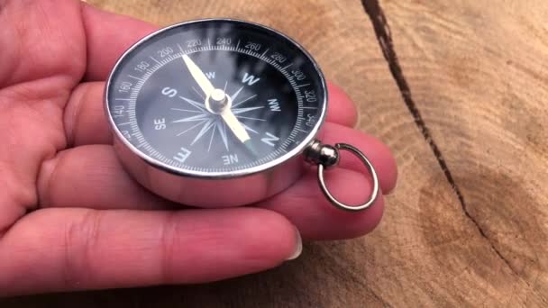 Round metal compass on the palm of the human female - Footage, Video