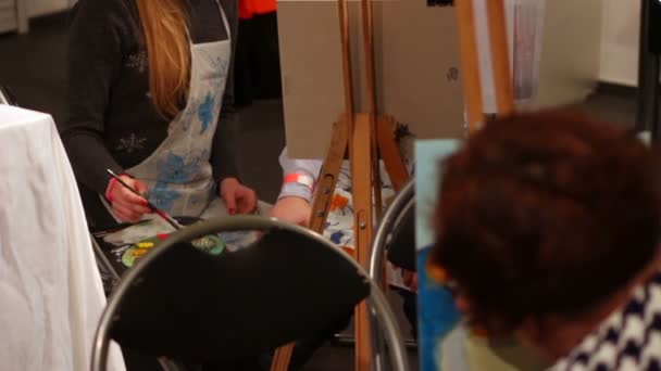 People painting pictures during masterclass at art school, interesting hobby - Felvétel, videó