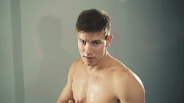 Portrait of handsome kickboxing man training in front of camera - Video, Çekim