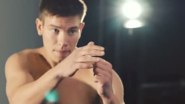 Handsome boxer training the kick in front of camera - Felvétel, videó