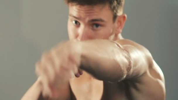 Portrait of handsome boxer kicks on the camera. Slowly - Séquence, vidéo