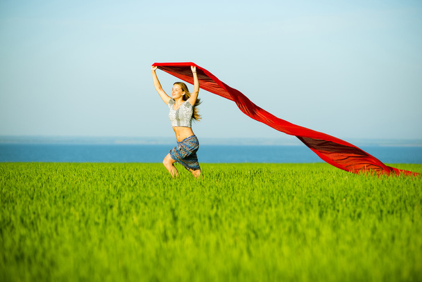 Young happy woman in wheat field with fabric. Summer lifestyle - Photo, Image