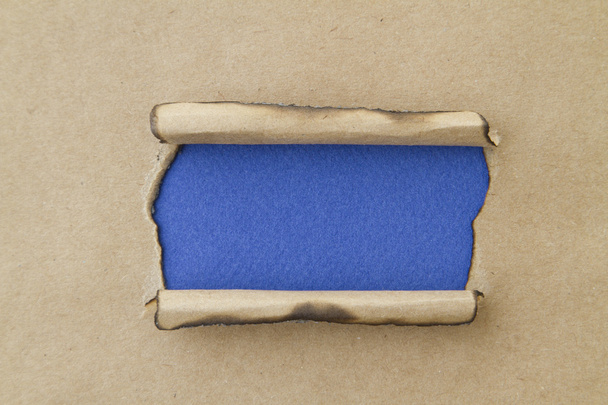 copy space on blue hole in cardboard - Zdjęcie, obraz