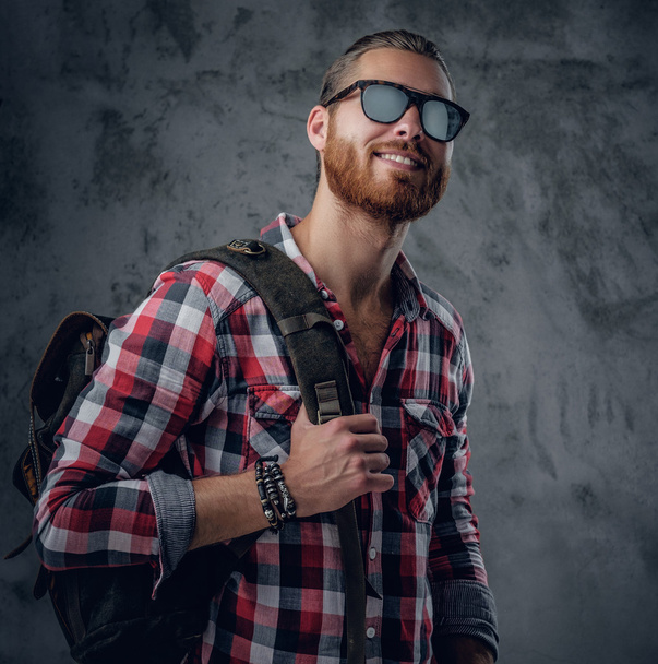 Voyageur urbain en lunettes de soleil tient sac à dos
 - Photo, image
