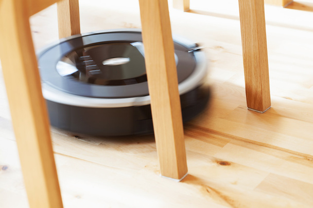 robotic vacuum cleaner on laminate wood floor smart cleaning tec - Foto, Imagen