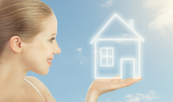 Concept housing, mortgage. woman holding in hand a house - Photo, Image