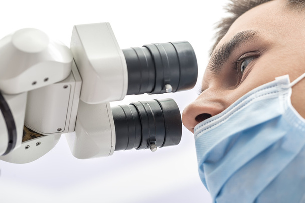Doctor using a dental microscope - Foto, Imagen