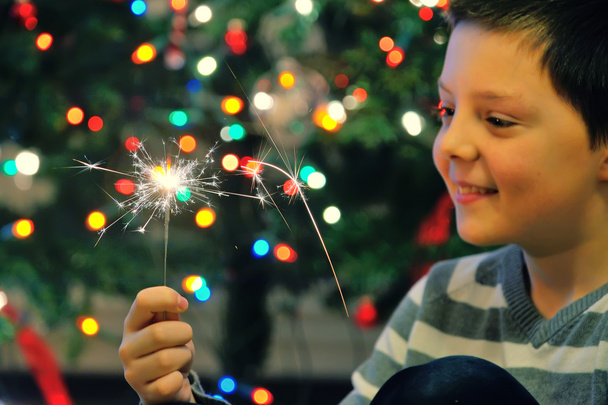 Young boy holding  sparkler  - Фото, зображення