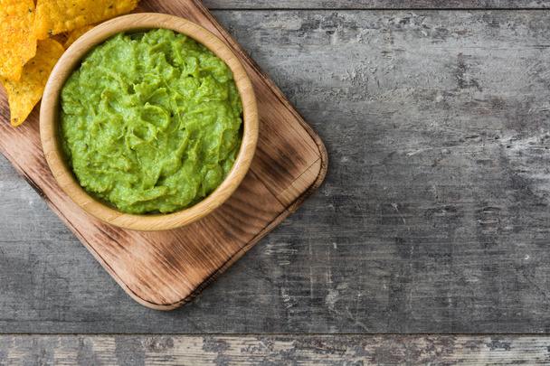 Nachos and guacamole on wooden background - 写真・画像