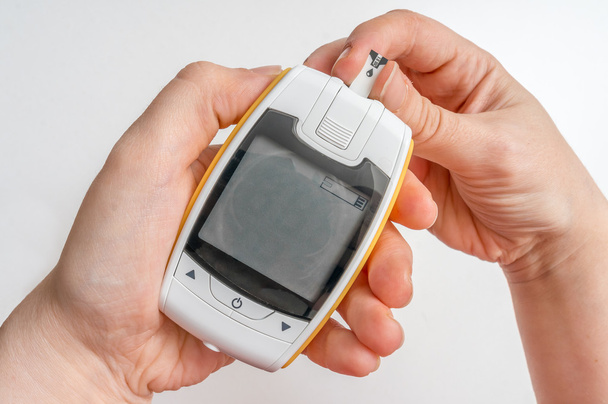 Paciente diabético está usando glucosímetro para medir el nivel de glucosa en sangre
. - Foto, Imagen