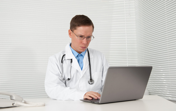 male doctor works on his laptop computer - Foto, imagen