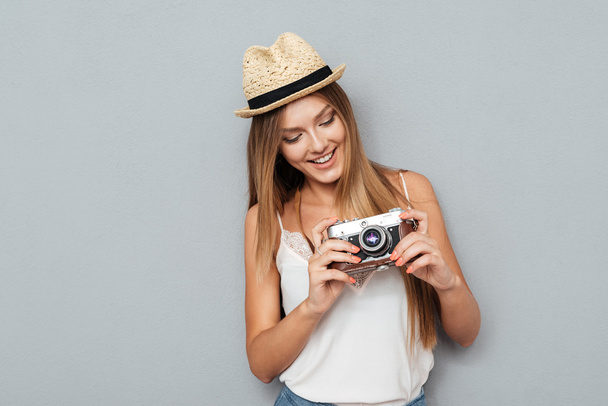 レトロなカメラを見て魅力的な笑顔の女性の肖像画 - 写真・画像