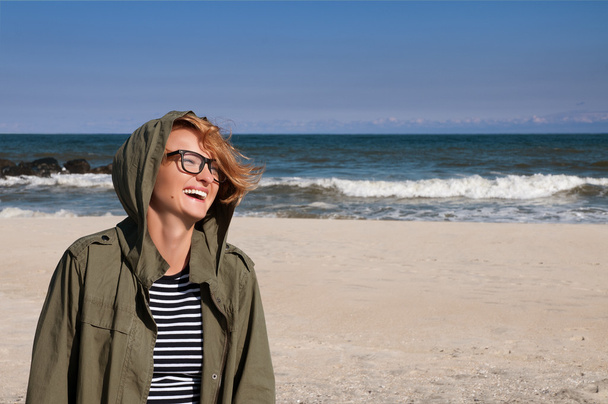 Portrait of beautiful happy woman on beach ocean in autumn - Foto, Bild