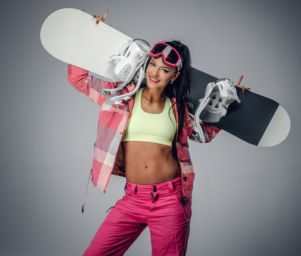 Female holding a snowboard on her shoulders - Foto, Bild