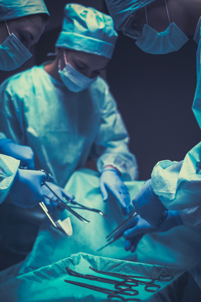 Team surgeon at work in operating room - Фото, изображение