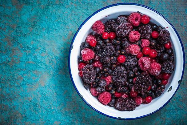 Frozen berries fruits in rustic bowl - Photo, Image