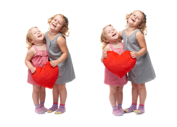 Couple of young little girls standing over isolated white background - Foto, afbeelding