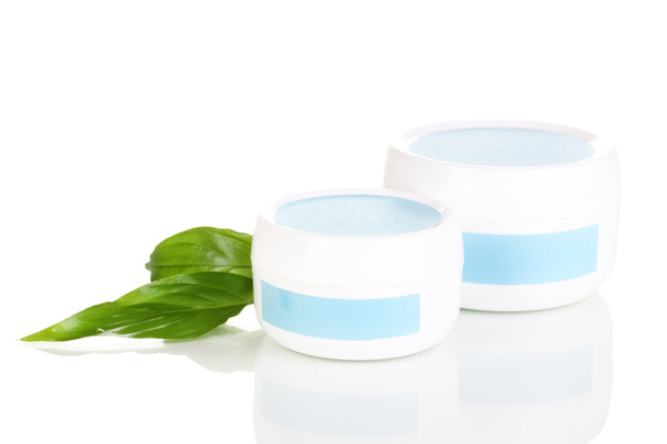 Jars of cream with green leaves isolated on white - Valokuva, kuva