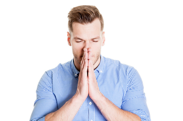 Portrait of a handsome man praying over white background - Foto, Imagem