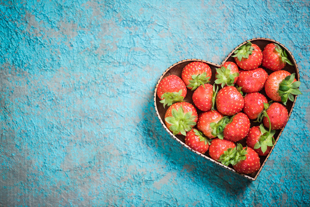 Strawberries in heart shape symbol - Фото, изображение