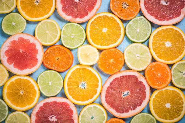 Exotic citrus slices overhead background - Photo, Image