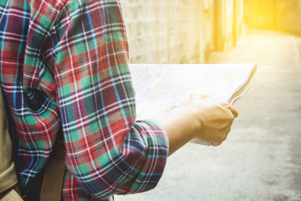 young tourist with a beard holding a map  choose where to travel - 写真・画像