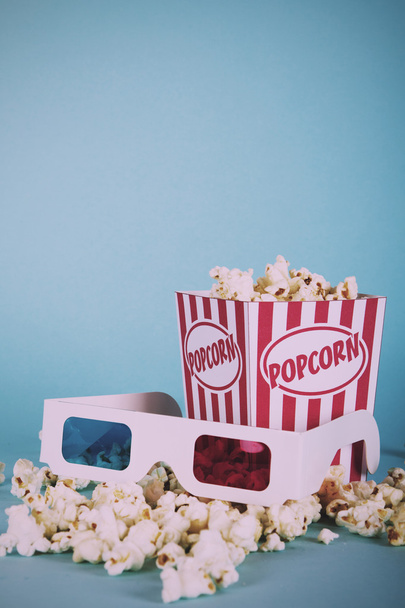 Popcorn bucket against a blue background Vintage Retro Filter. - Foto, Imagem