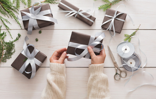 Gift wrapping. Packaging modern christmas present in boxes - Photo, Image