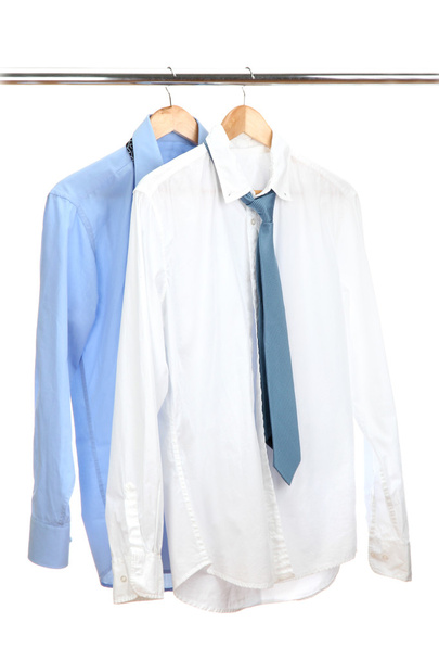 blue and white shirts with tie on wooden hanger isolated on white - Fotó, kép