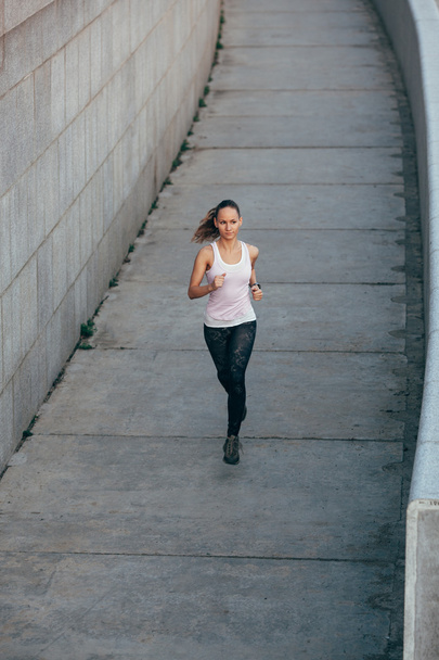 woman running in concrete urban scape - Zdjęcie, obraz