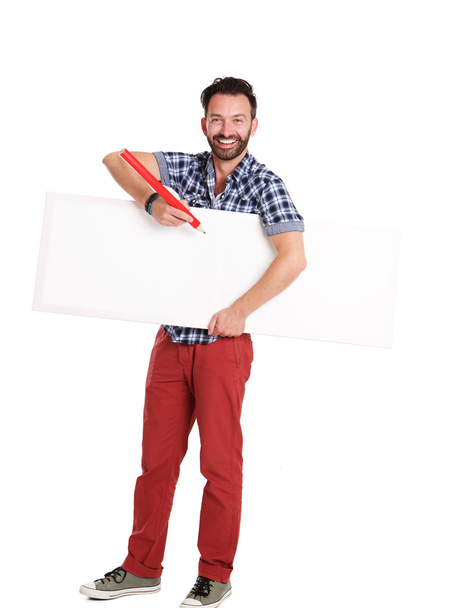 Handsome mature man writing on blank poster - Photo, image
