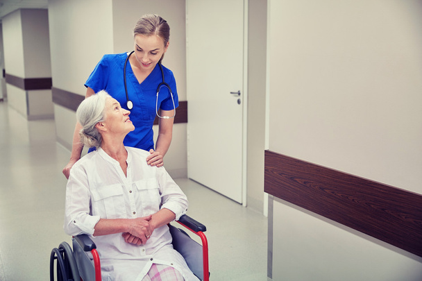 nurse with senior woman in wheelchair at hospital - Фото, зображення