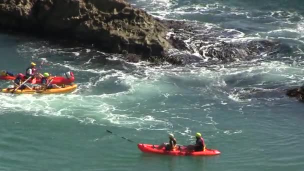 Yellow canoe near rocks in the sea - Footage, Video