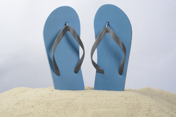 Blue thongs on the sand - Foto, Imagen
