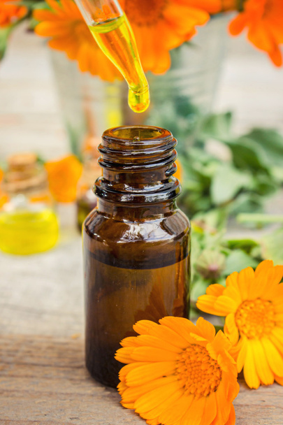 Small bottle of calendula oil (Pot marigold extract, tincture, infusion) - Фото, изображение