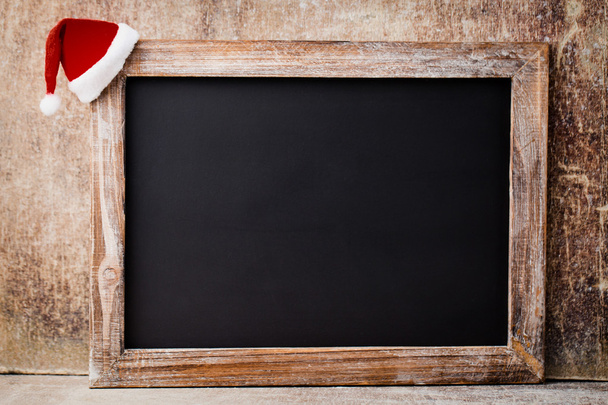 Christmas chalkboard and decoration over wooden background. - Фото, зображення