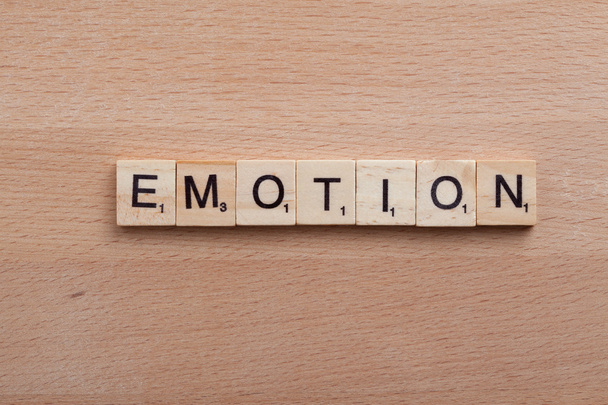 Scrabble letters spelling the word emotion. - Foto, Imagen