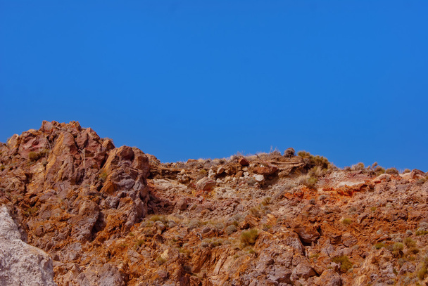 Red-grey-ochre-rocks-under-blue-sky - Photo, Image