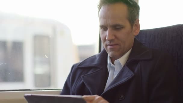 Business Man types into his digital tablet - Imágenes, Vídeo