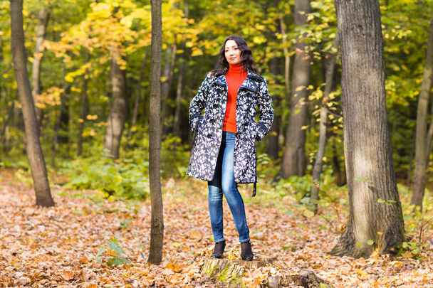 Autumn concept - Beautiful young modern woman on nature - Фото, изображение