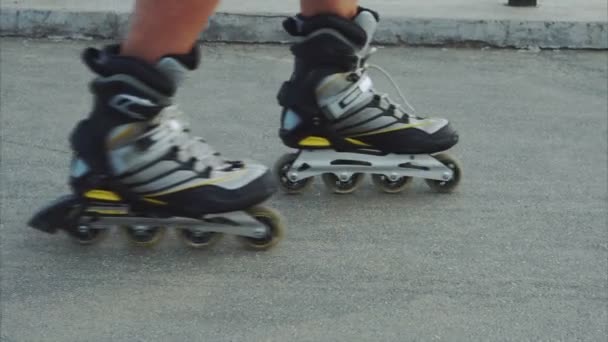 Mans legs roller skating inline close up on the asphalt - Footage, Video