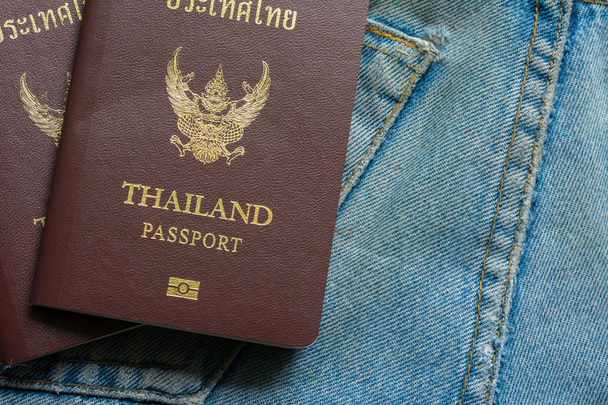 Thai passport in blue jeans pockets , traveler concept  - Photo, Image