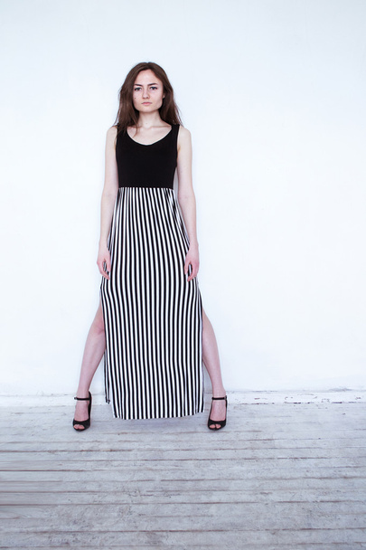 photo girl in a striped dress standing on a white background - Photo, image