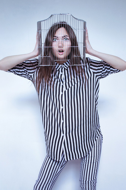 photo portrait of a girl in a striped clothes to a cell on his head - 写真・画像
