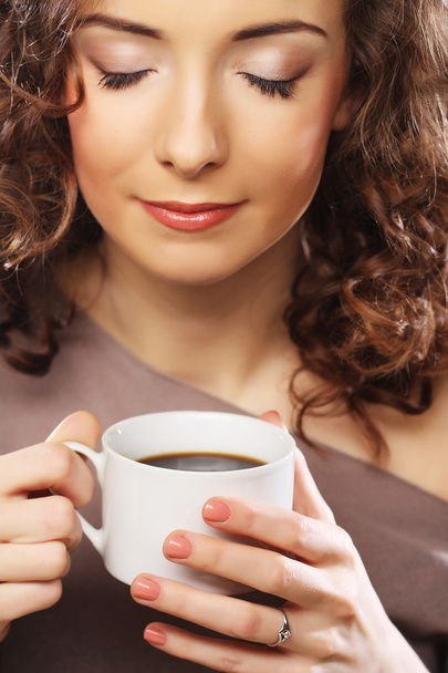 young curly woman drinking coffee - Fotó, kép